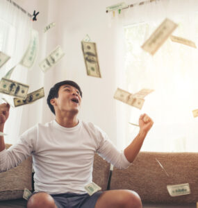 happy man with cash dollars flying home office rich from business online concept