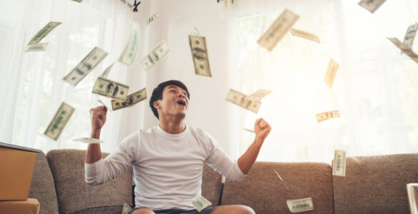 happy man with cash dollars flying home office rich from business online concept