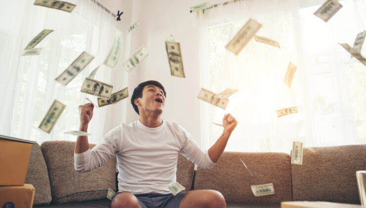 happy man with cash dollars flying home office rich from business online concept