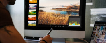 man editing photos computer