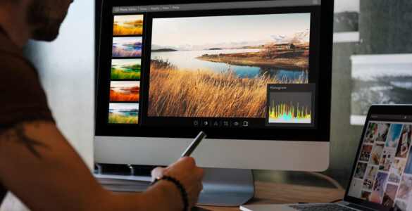 man editing photos computer